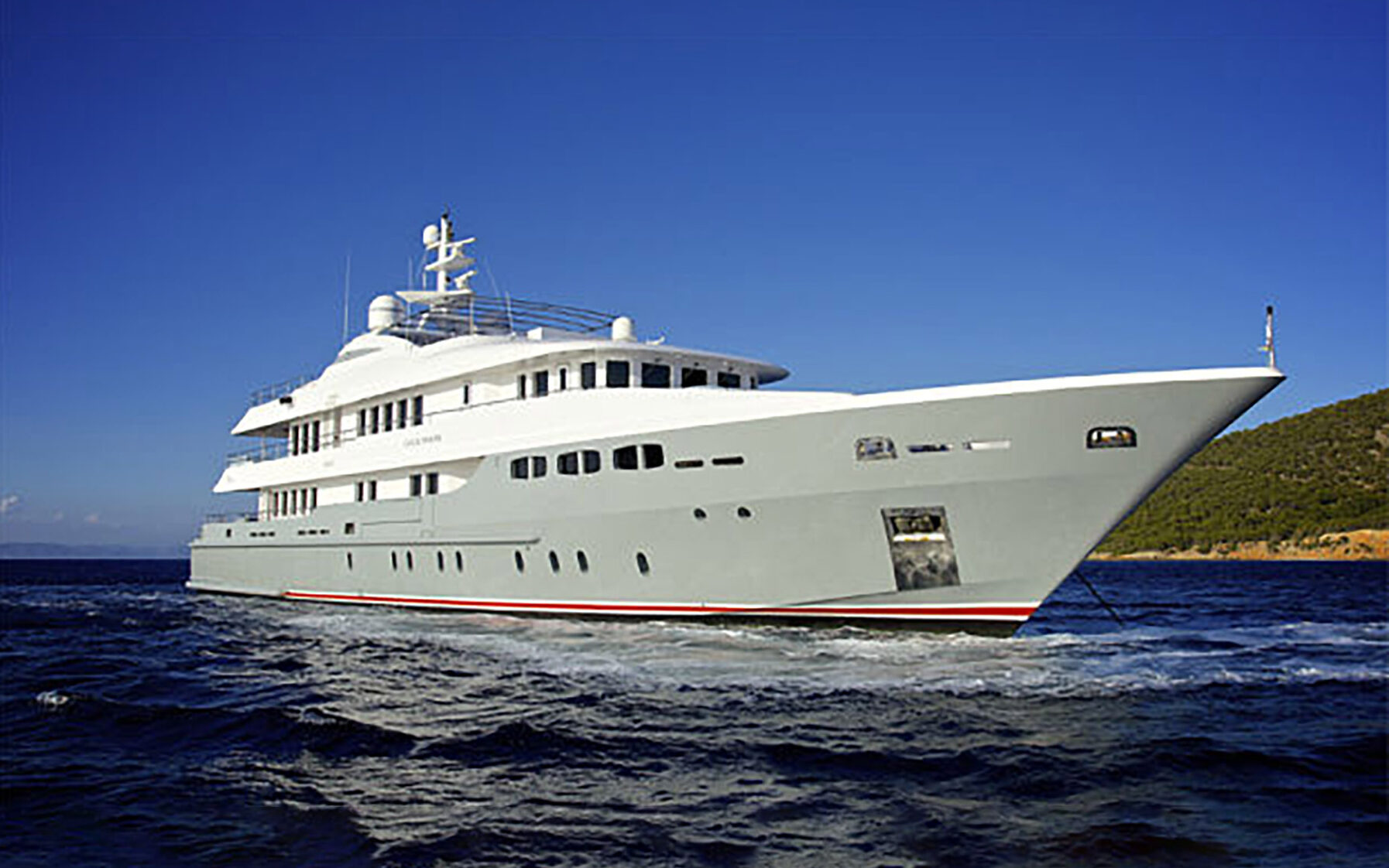 The exterior deck of the Light Holic with sun beds and the sun shining.