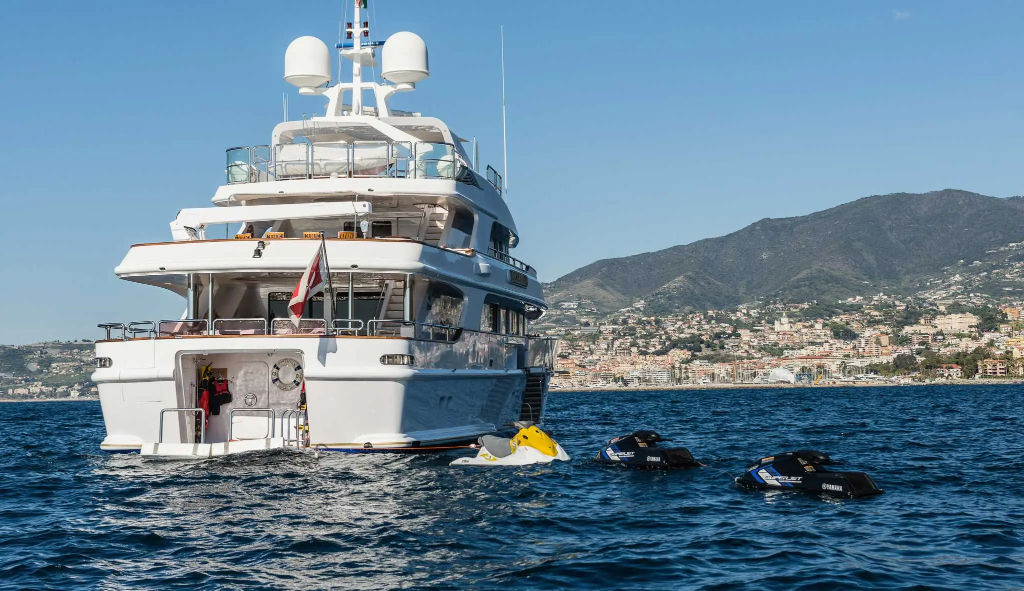 Back view of Desamis B with two jet skis beside it.