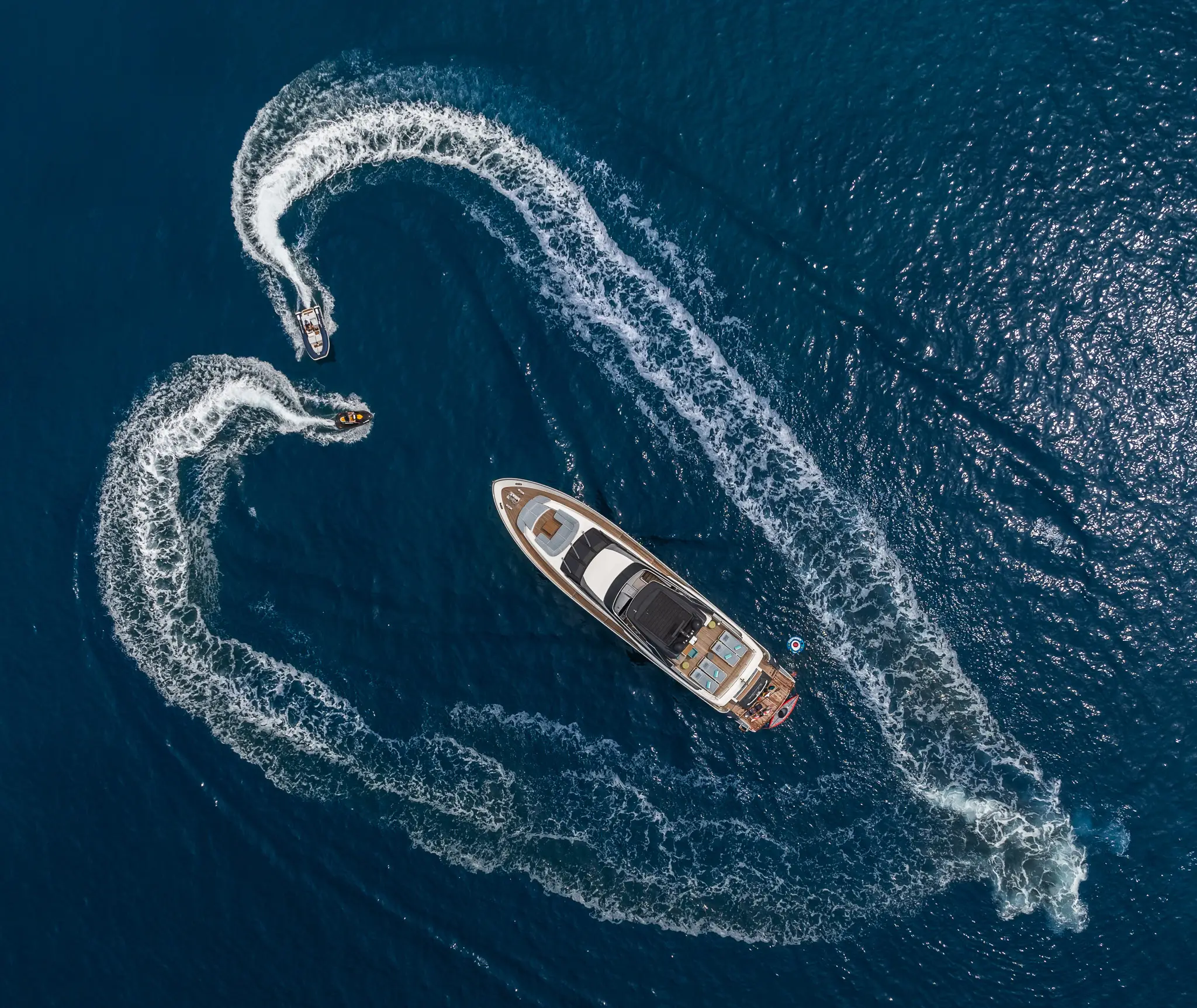 The yacht Pembe from birds eye view with two jet skis making a heart around it.