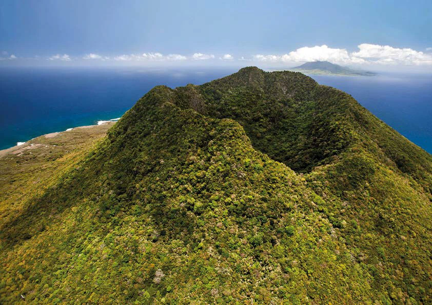 A volcano covered in greenery on the uninhabited Ile Fourchue.