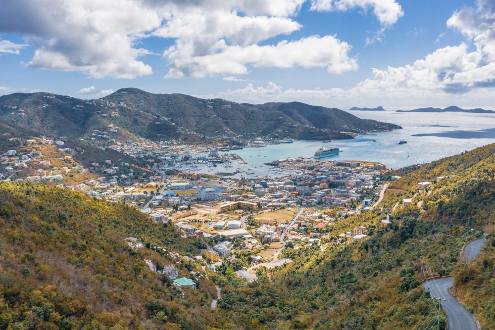 The artisan market of St Thomas leading to the harbour, with vessels on the water.
