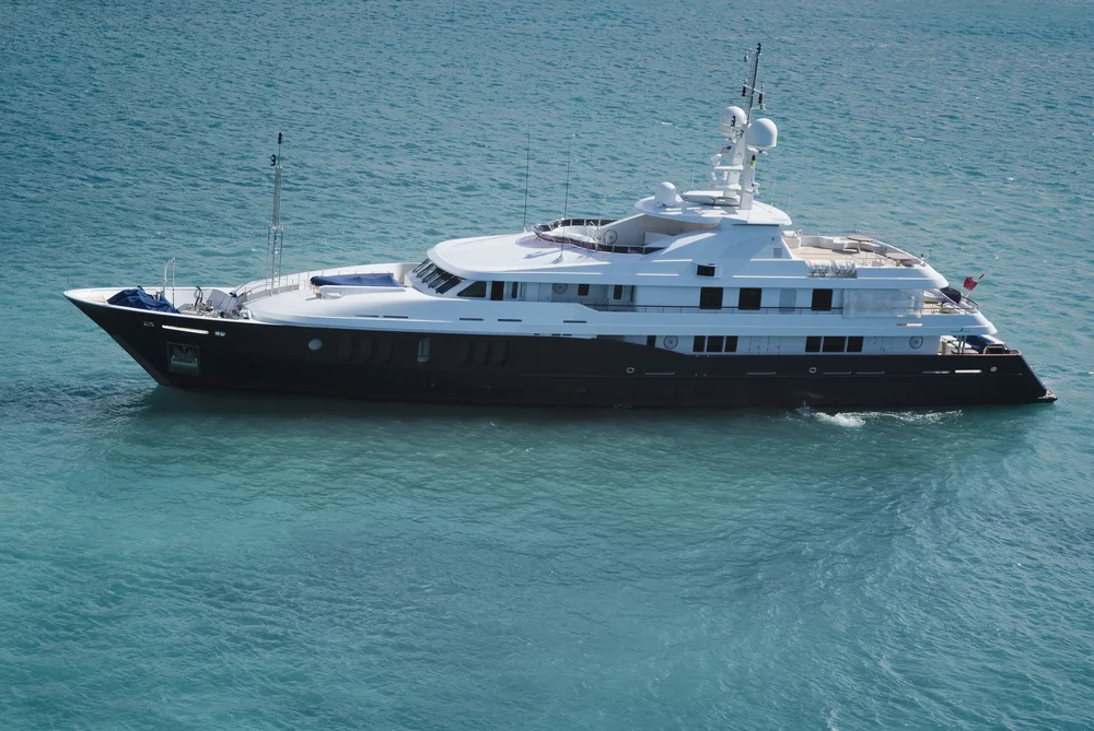 A superyacht floating through the clear waters of the Caribbean.