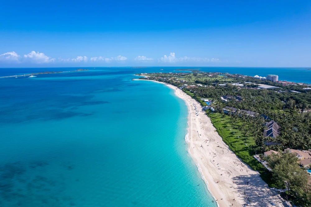 Turquoise waters close to the white beach and green of Paradise Island.