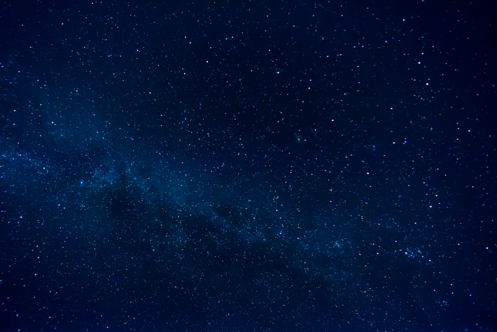 A navy night sky with stars shining.