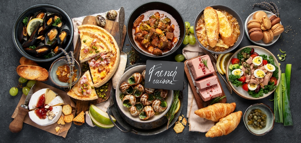 A selection of French Cuisine, with bouillabaisse, cheeses, quiche and more.